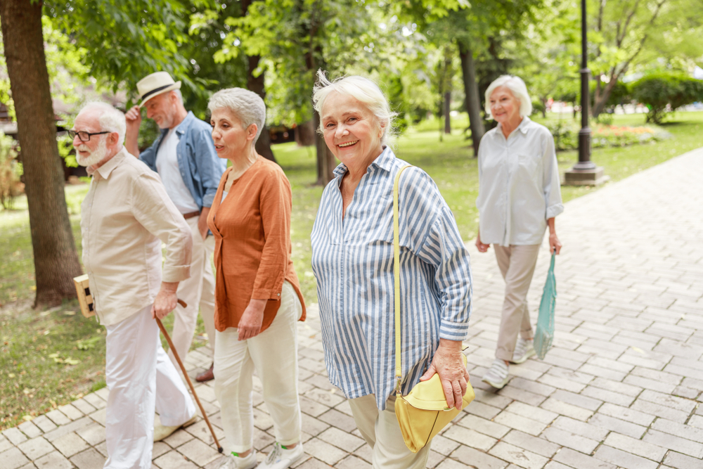 A group of seniors walking down a white brick sidewalk