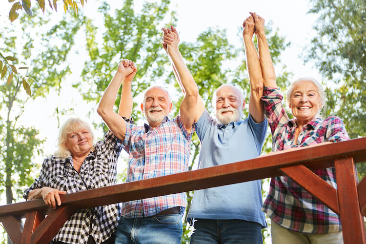 Group of seniors taking a walk around their continuing care retirement community.