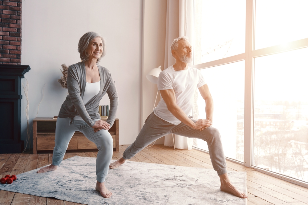 senior couple doing yoga at home
