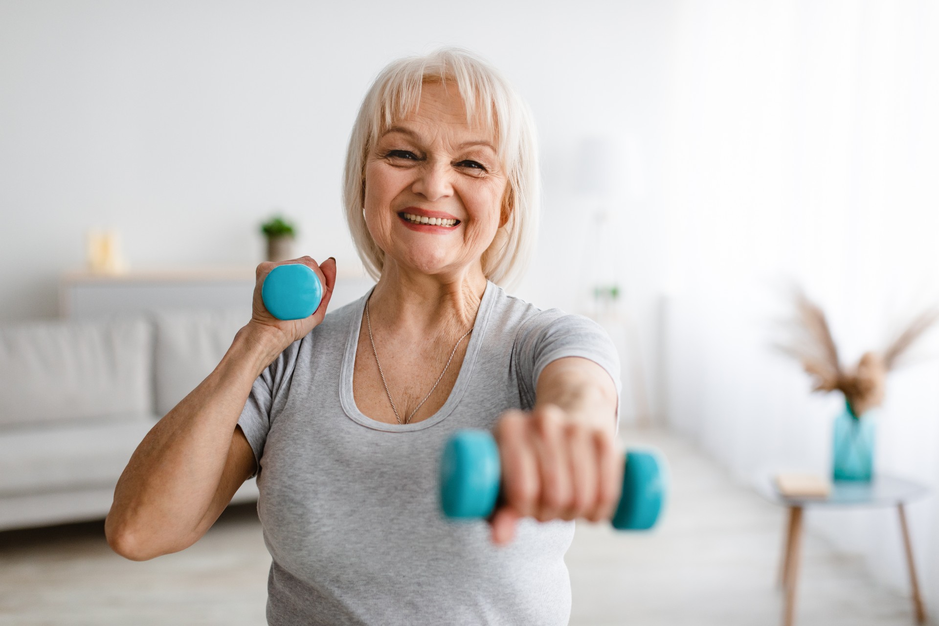 Happy senior woman exercising at home