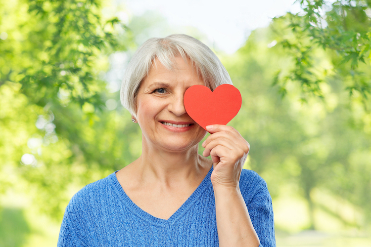 Senior woman celebrating American Heart Month.