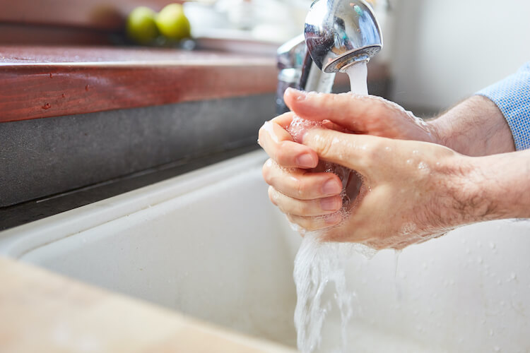 Senior washing their hands.