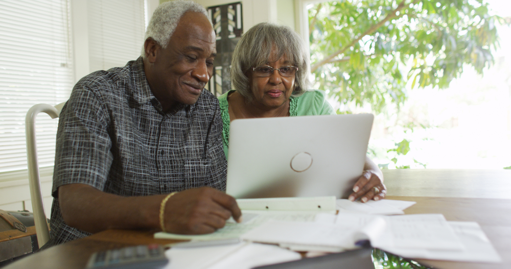 Senior couple looking at a laptop together