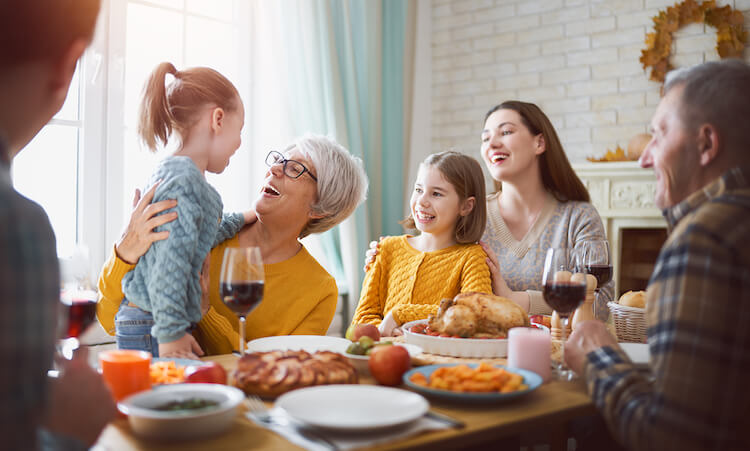 A family gathers at a table for a holiday meal.