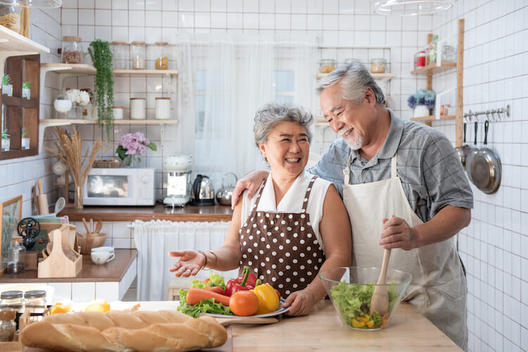 Senior couple cooking during National Nutrition Month.