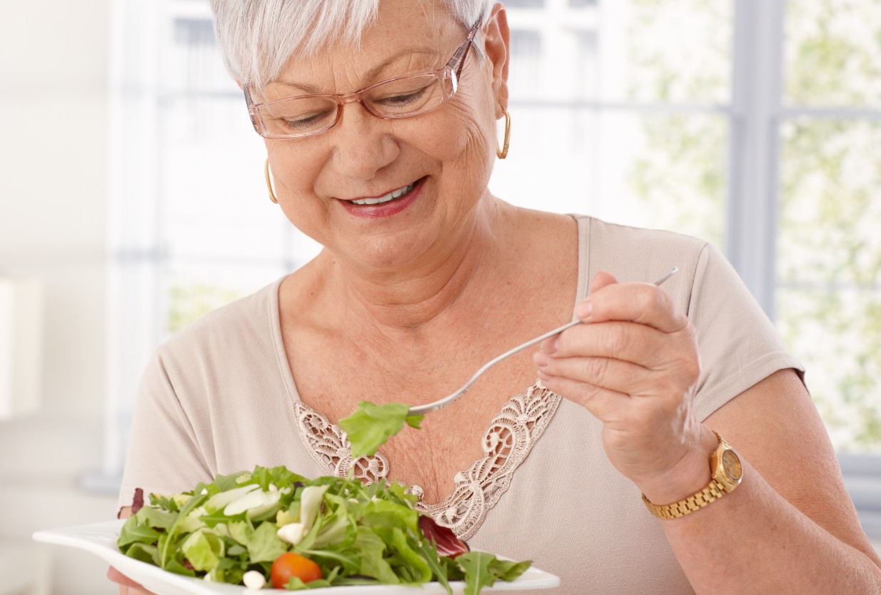 Senior woman eating a healthy salad