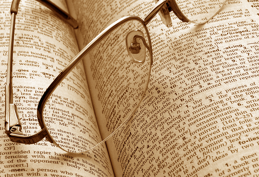 Glasses sitting on top of a book of senior living terms.