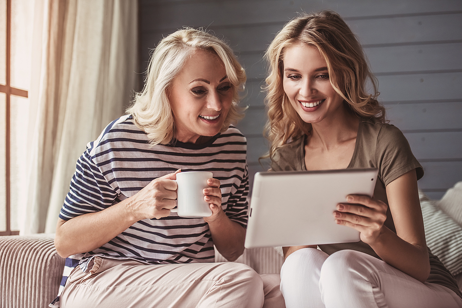 Senior mom and adult daughter discuss moving to a senior living community